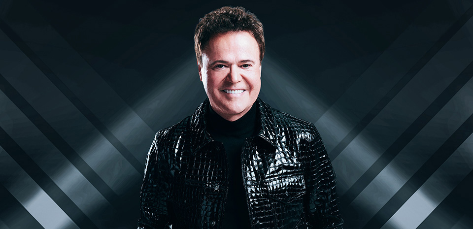 Donny Osmond performing live on stage in 2026